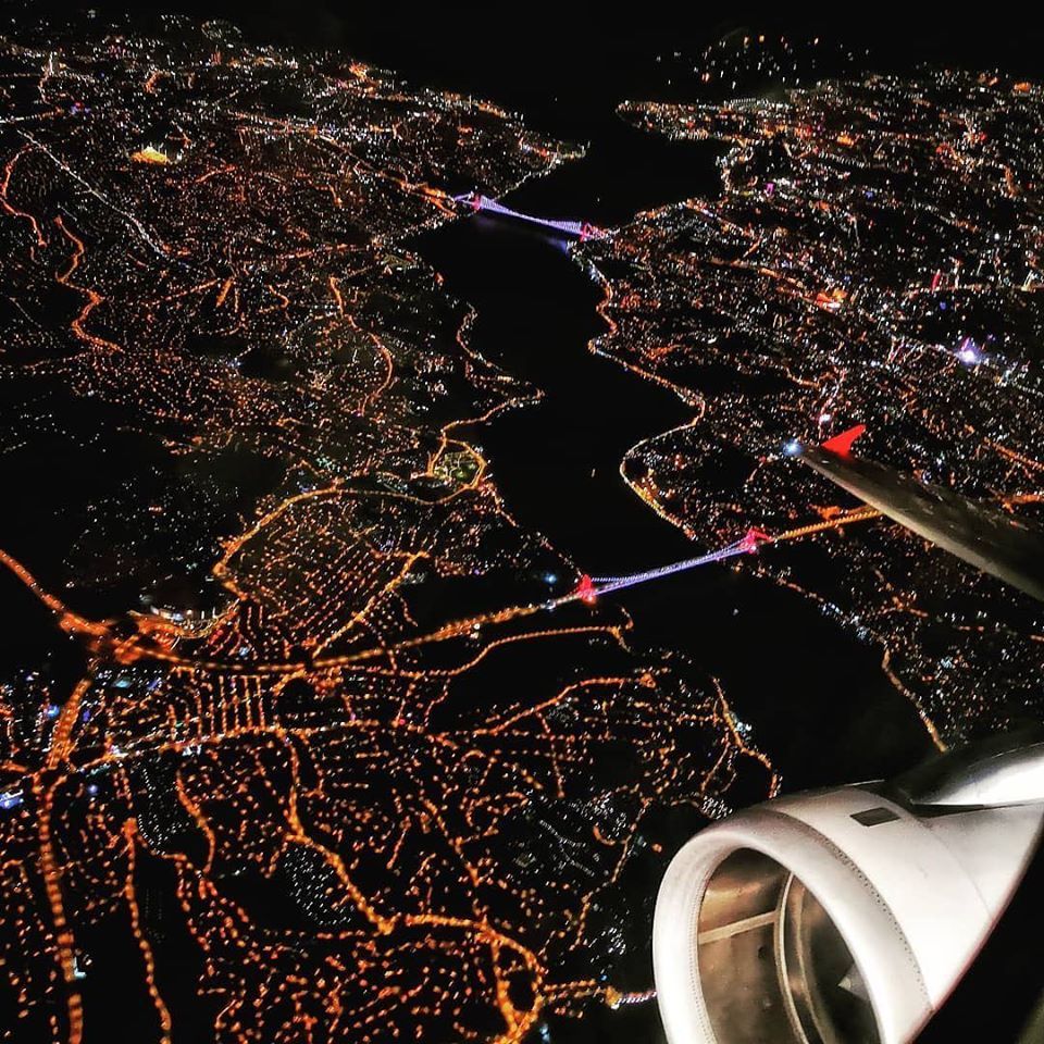 City lights at night seen from the cabin window